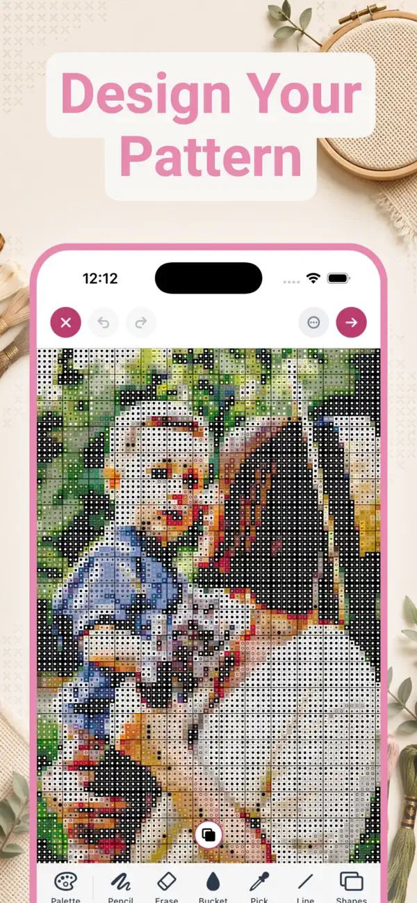 StitchCraft pattern editor on iPhone showing a cross stitch grid with symbols and drawing tools